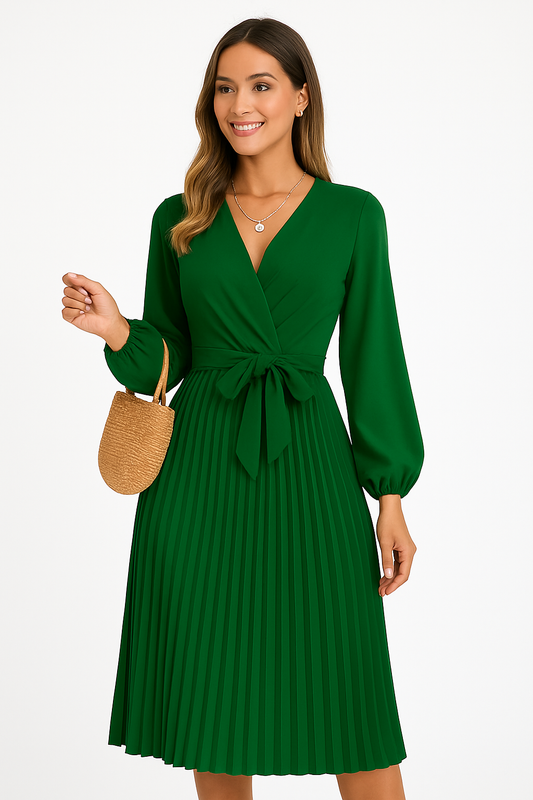 Woman wearing elegant green pleated maxi dress with long sleeves and cross-front design holding a straw handbag
