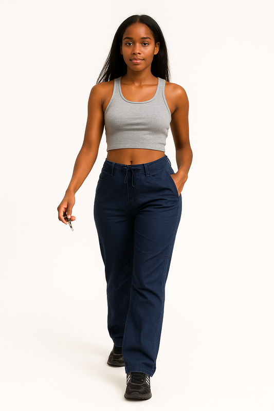 Woman wearing navy vintage street cargo wide-leg jeans with pockets and a gray crop tank top walking against a white background