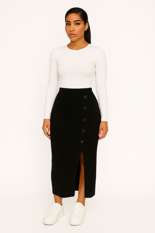 Woman wearing a black ChicCurve button-slit ribbed knit high-waist midi skirt with side buttons and a front slit, paired with a white long-sleeve top and white sneakers.