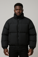 Man wearing a black Casual Fashion Gradient cotton puffer coat with a front zipper and high collar.