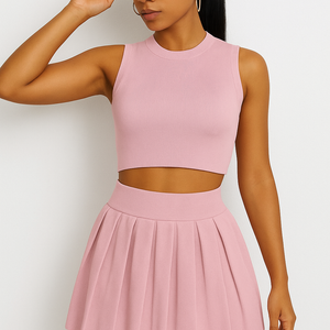 Solid color round neck sleeveless vest and high-rise pleated short skirt set for women.