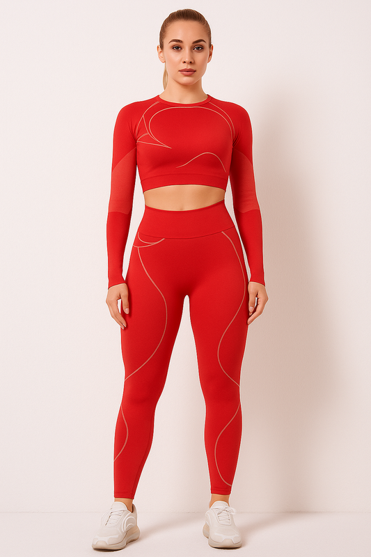Woman wearing red TrendFlex Fitwear sport suit yoga set with long sleeves and high-waisted leggings, standing against a plain background.