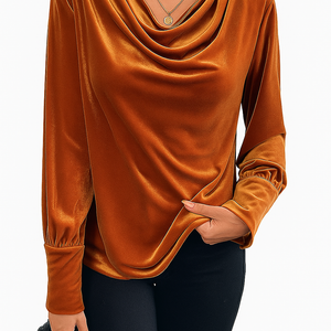 Woman wearing a vintage velvet elegant swing collar shirt in rich brown with long sleeves and subtle gathering at cuffs, paired with black pants.